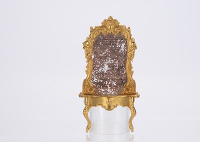 Lot 1021 - A gilt metal dolls’ house consul table and mirror