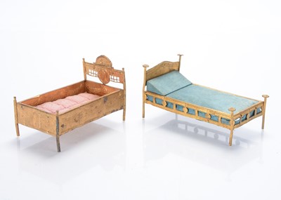 Lot 1023 - Gilt metal dolls’ house beds