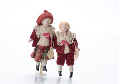 Lot 1032 - A pair of German bisque shoulder-head dolls’ house dolls