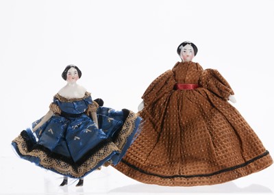 Lot 1035 - Two 19th century German china shoulder-head dolls’ house dolls