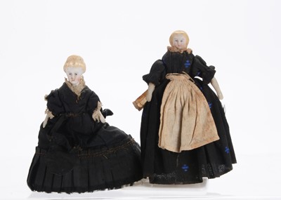 Lot 1044 - Two 19th century German bisque shoulder-head dolls’ house dolls