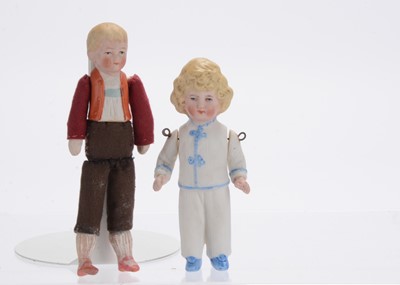 Lot 1045 - A German all-bisque dolls’ house doll in pyjamas