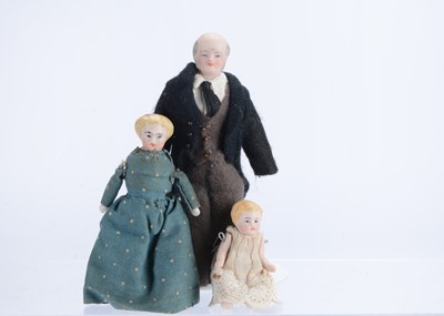 Lot 1048 - Three dolls’ house dolls