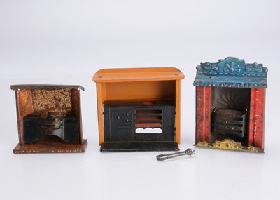 Lot 1104 - Two tinplate dolls’ house fireplaces and a range
