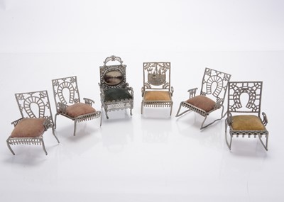 Lot 1115 - Five Adrian Cooke Metallic Works (Chicago) ‘The Fairy Furniture’ soft metal dolls’ house chairs