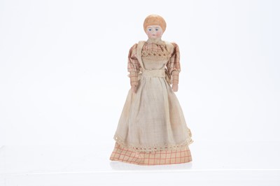 Lot 1132 - A German bisque shoulder-head dolls’ house housekeeper doll