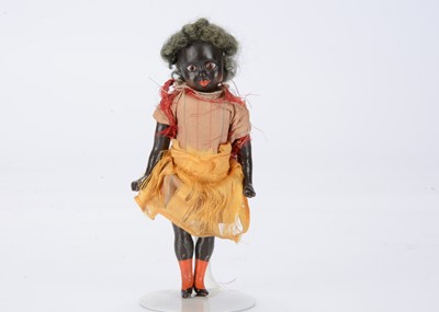 Lot 1375 - A small late 19th century German composition black girl doll