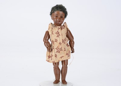 Lot 1376 - A small Recknagel black doll with jointed body