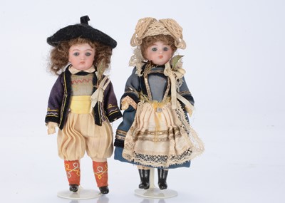 Lot 1377 - Two small German bisque headed dolls in European traditional costume