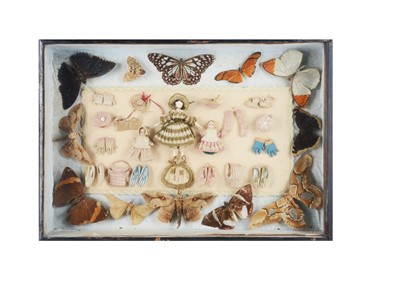 Lot 1459 - A mid 19th century shadow box with Grodnerthal and wax dolls’ house dolls and finely knitted doll’s accessories