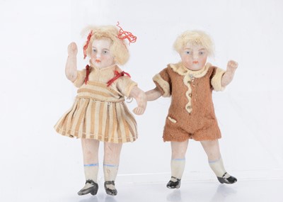 Lot 1469 - A German all-bisque dolls’ house brother and sister doll
