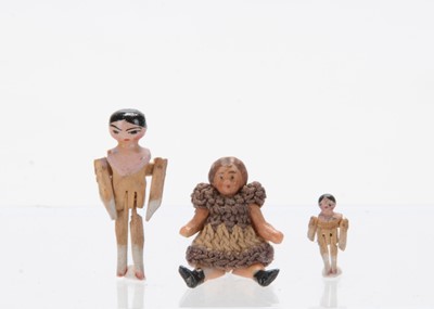 Lot 1497 - A small and tiny German pegged wooden doll