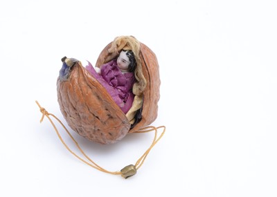 Lot 1500 - An 19th century china Frozen Charlotte doll in a walnut shell