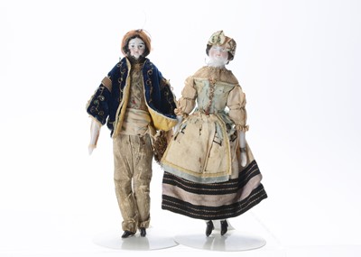 Lot 1507 - A pair of mid 19th century German china shoulder-head dolls’ house dolls