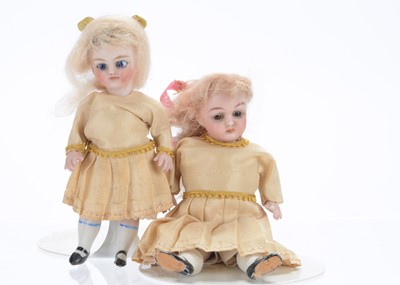 Lot 1560 - Two German all-bisque dolls’ house sisters