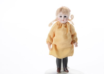 Lot 1561 - A German all-bisque dolls’ house doll marked 190