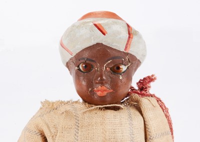 Lot 1588 - An unusual 19th century composition black doll in turban