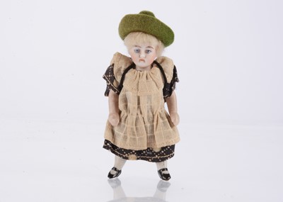 Lot 1589 - A German all-bisque dolls’ house school girl
