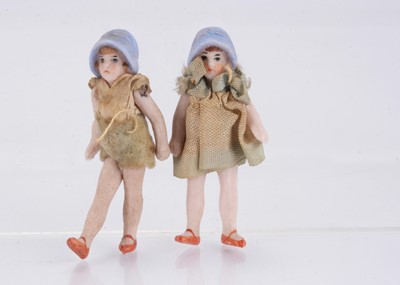 Lot 1592 - A Hertwig all-bisque boy and girl in moulded blue sun hats