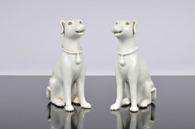 Lot 104 - A pair of Chinese Blanc De Chine porcelain dogs