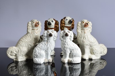 Lot 146 - Three pairs of Victorian and later Staffordshire pottery mantle spaniels