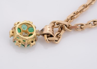 Lot 157 - An 18ct gold emerald and diamond cluster pendant