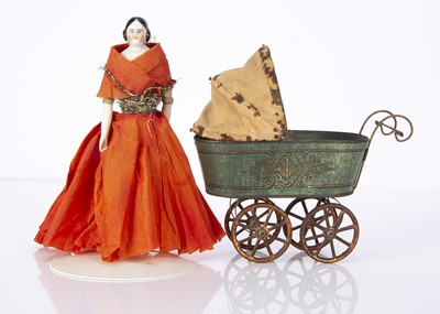 Lot 1389 - A lithographed tinplate perambulator and china shoulder-head doll