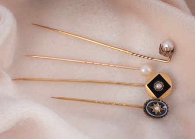 Lot 13 - Four pearl set stick pins