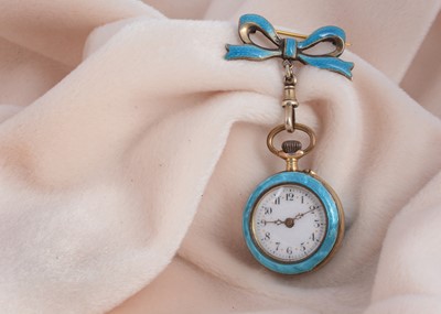 Lot 47 - A continental silver gilt and enamel lady's fob watch and matching bow brooch
