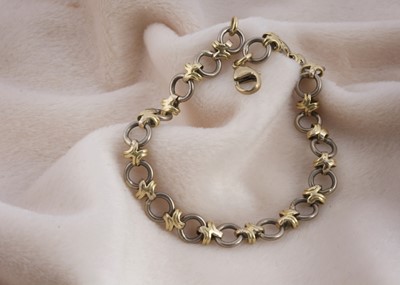 Lot 154 - An 18ct gold two colour circle and cross designed bracelet
