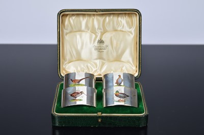 Lot 254 - A fine set of four George V period silver and enamel napkin rings from C.P. & Co.