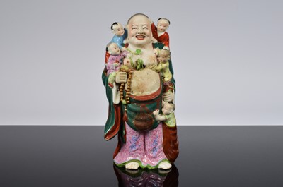 Lot 242 - A Chinese porcelain figure of Buddha and children