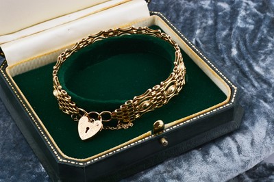 Lot 7 - A 9ct gold celebration gate bracelet