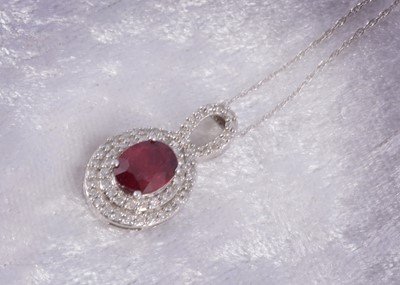 Lot 174 - A 9ct white gold ruby and diamond pendant and chain