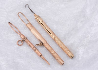 Lot 215 - Three gold plated Edwardian button hooks