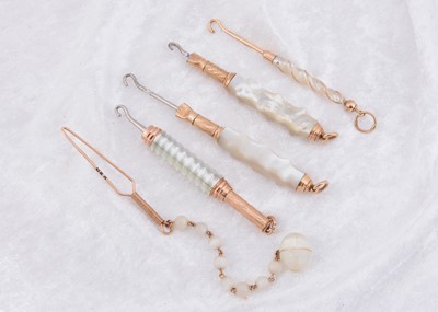 Lot 244 - A collection of mother of pearl and gilt metal button hooks