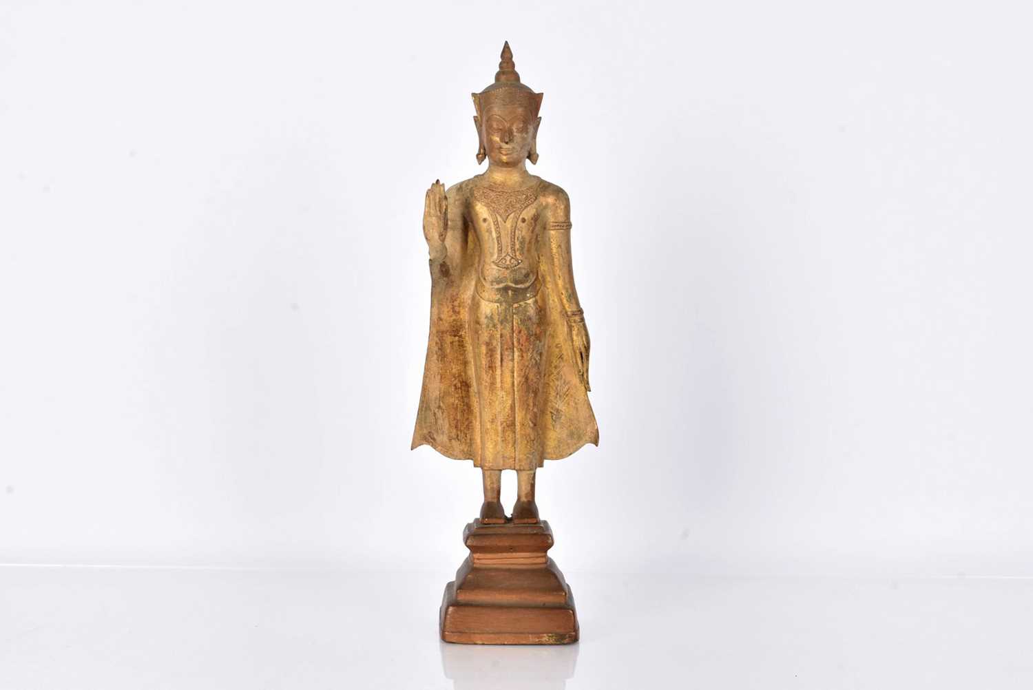 Lot 25 - A bronzed cast metal figure of a Standing Crowned Buddha in Abhayamundra
