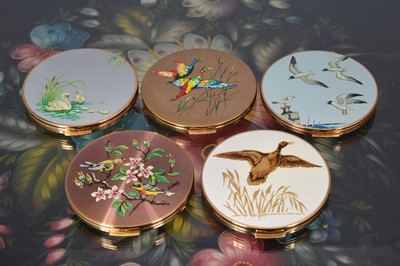 Lot 526 - Five gilt metal and coloured enamel decorated 1970s circular Stratton powder compacts