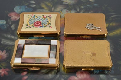 Lot 559 - Four shaped rectangular 1950s Kigu gilt metal compacts