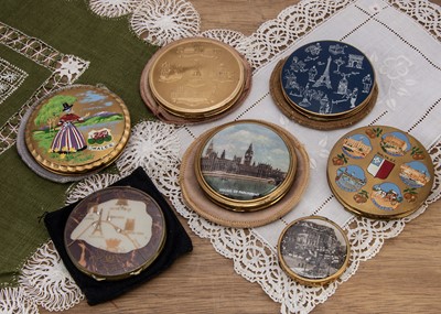 Lot 597 - A collection of seven circular souvenir compacts