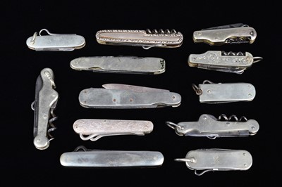 Lot 702 - An assortment of base metal and white metal Multi-Tools/Pocket Knives
