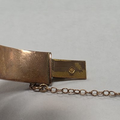 Lot 3 - A 9ct gold hinged oval bangle