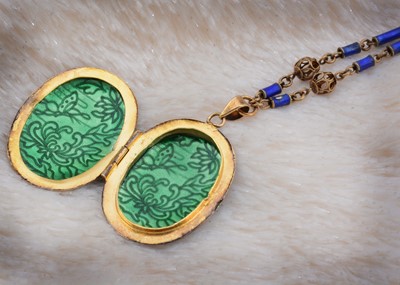 Lot 43 - A Chinese silver gilt and enamel oval locket