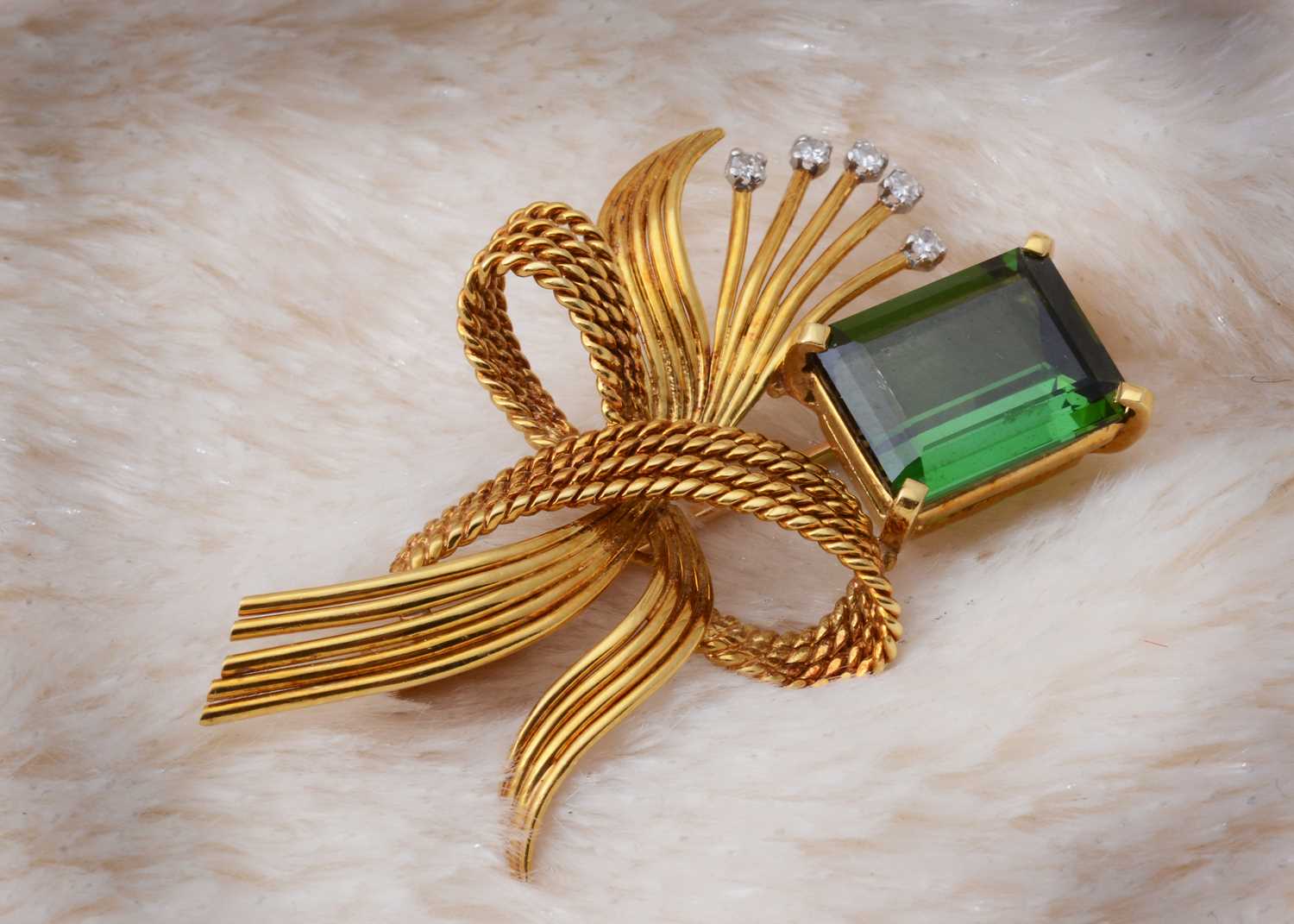 Lot 48 - A continental tourmaline and diamond bow brooch