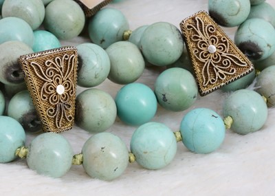 Lot 79 - A string of turquoise knotted beads
