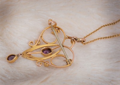 Lot 87 - An art nouveau 9ct gold amethyst and seed pearl heart shaped pierced necklace
