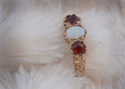 Lot 125 - A 9ct gold garnet and opal three stone ring