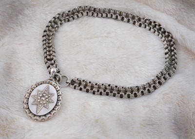 Lot 138 - A white metal Victorian locket and chain