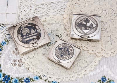 Lot 281 - Three niello style decorated square compacts