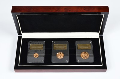 Lot 100 - A modern London Mint Office Platinum Anniversary three coin gold sovereign set